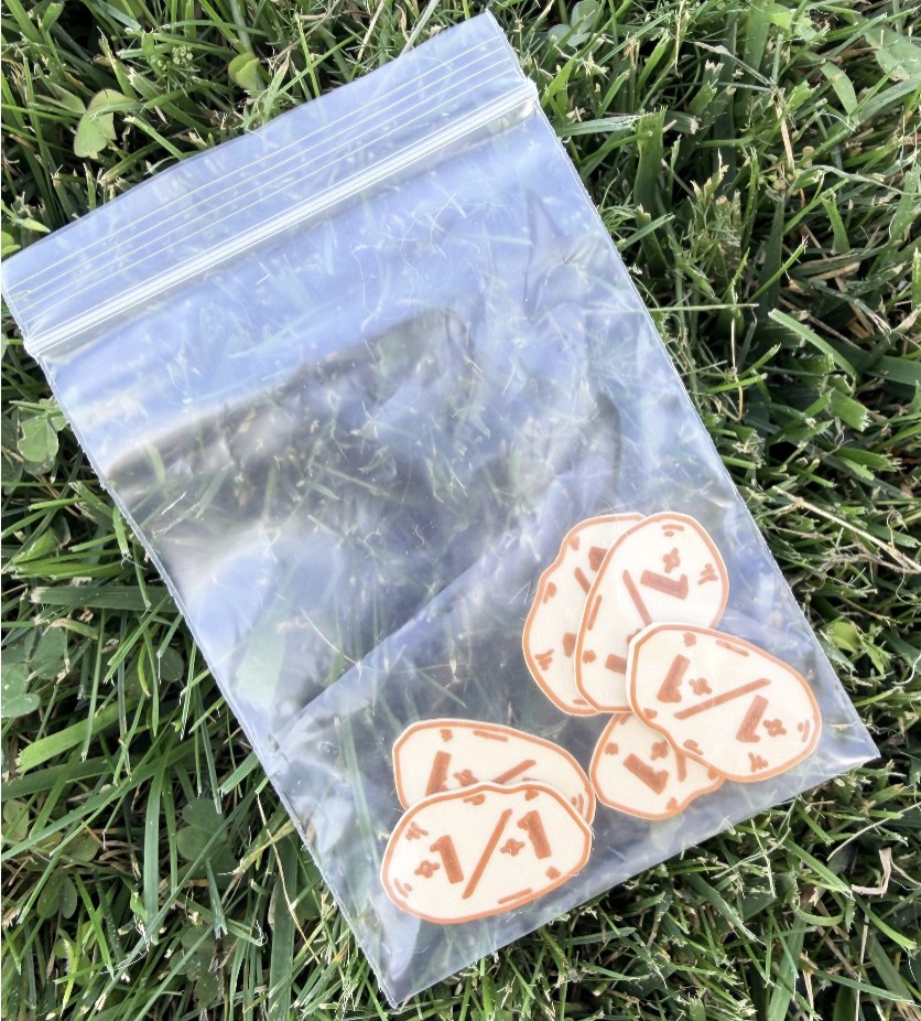 Bag of handmade wooden potato shaped 1/1 game counters with burnt line details
